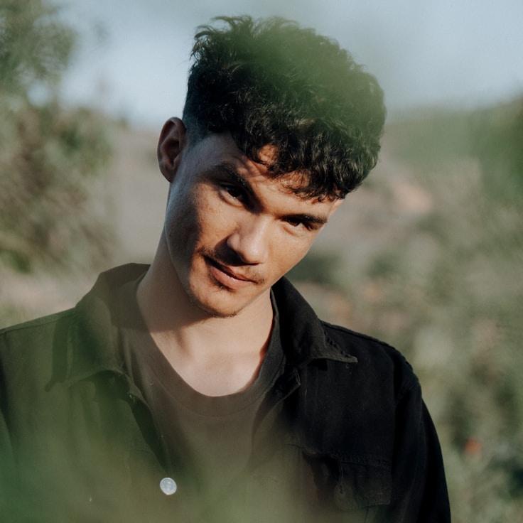 Avery Chen, Lead Design Curator at Kernel Bright Studio, reviewing corporate floral arrangements